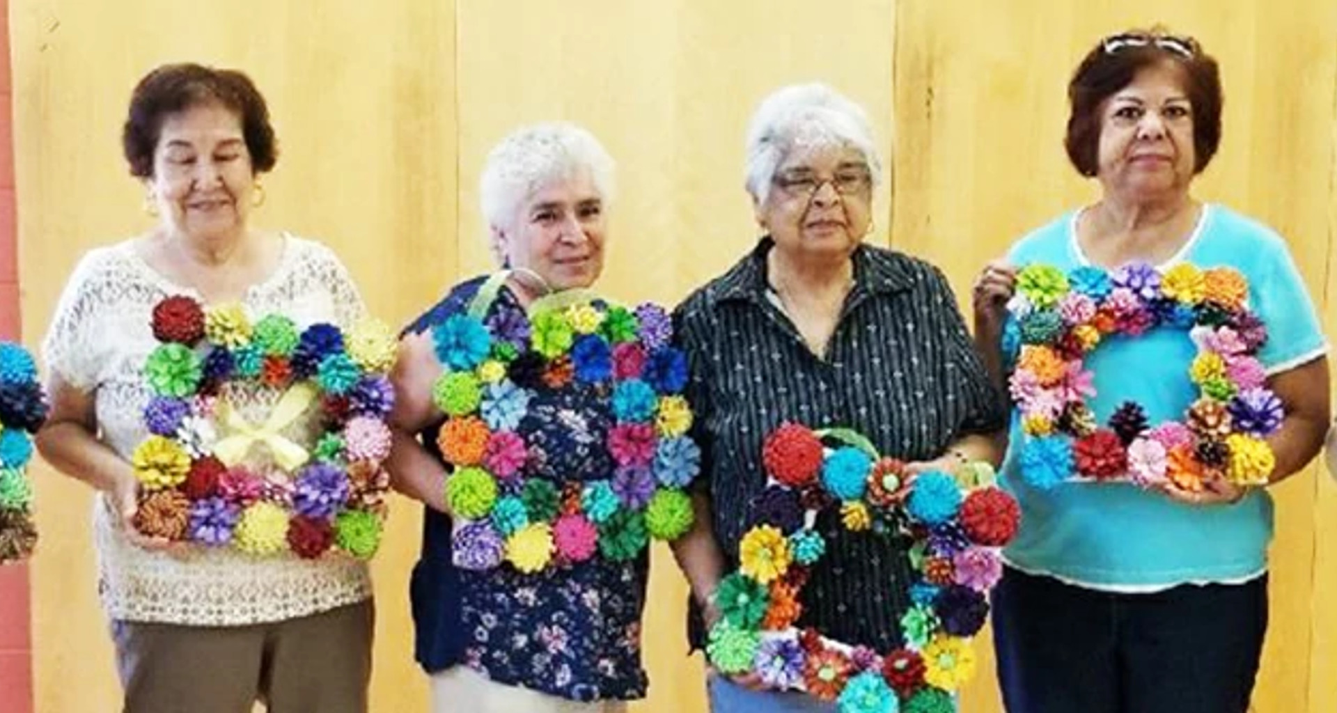 Seniors posing with frames they made out of flowers